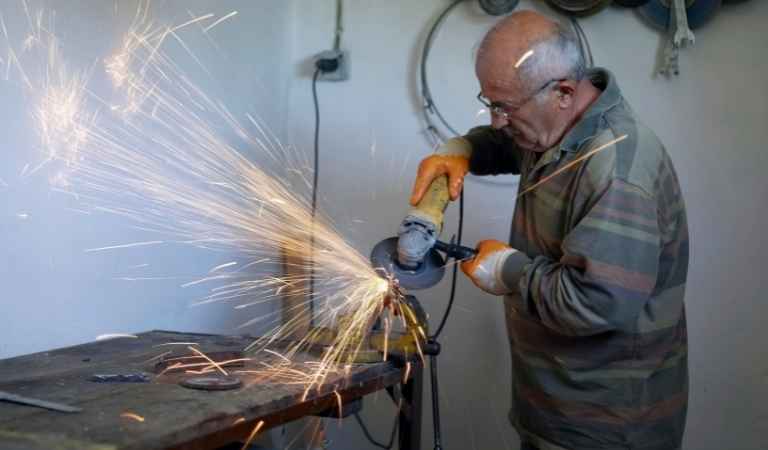 blacksmith using power tools