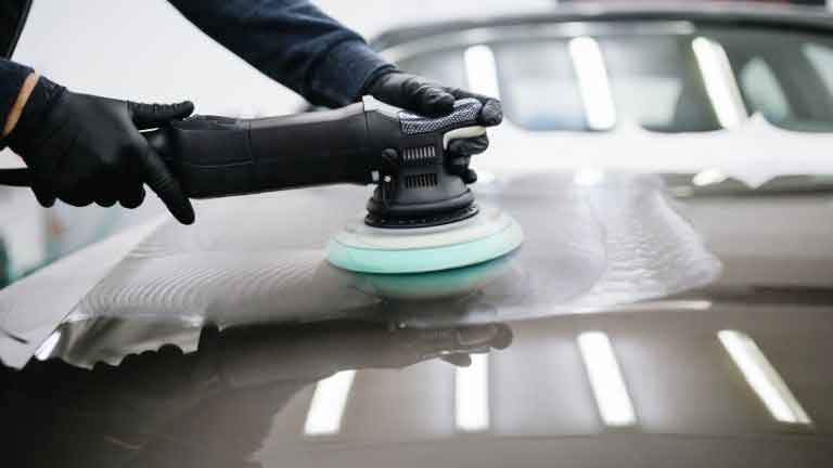 buffing the car with a dual action car polisher