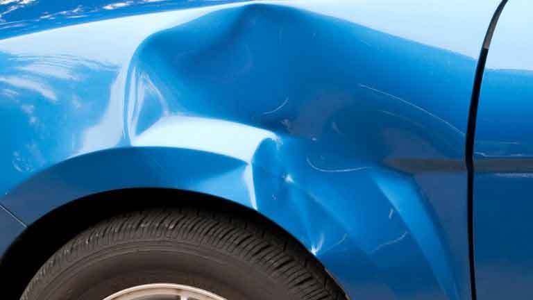 damaged car fender being rolled with a fender roller