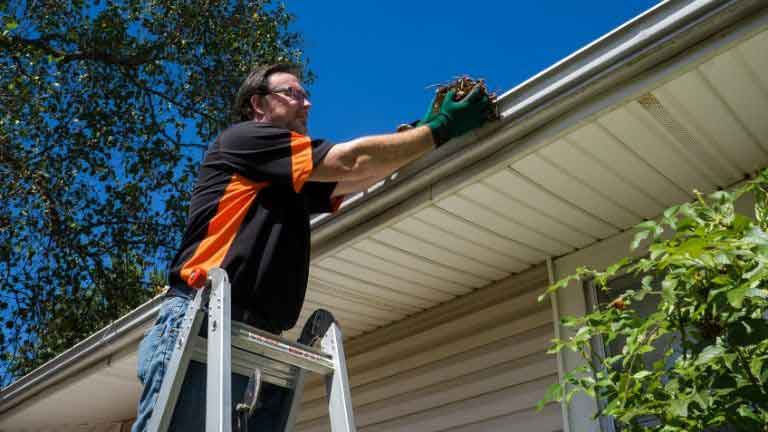 utilizing ladder for cleaning gutter